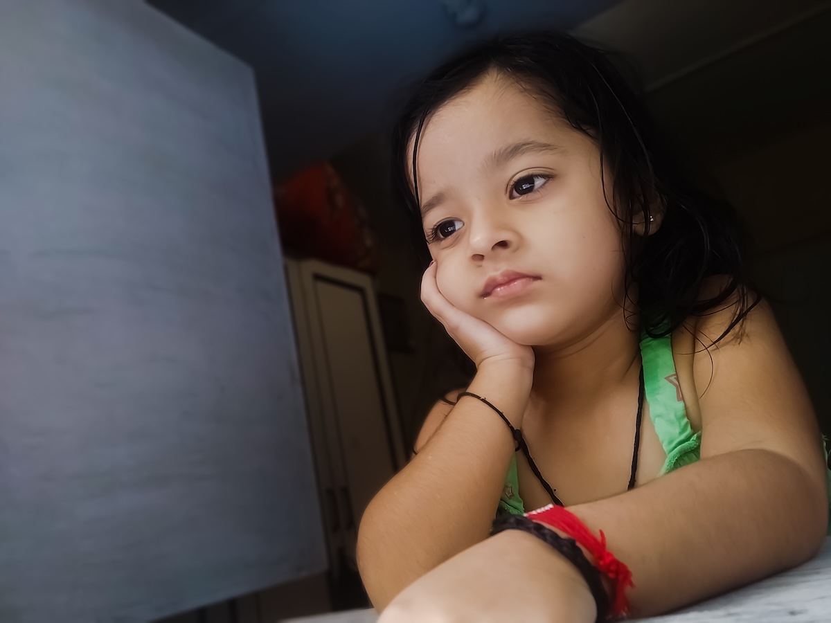 thoughtful-cute-girl-looking-through-window